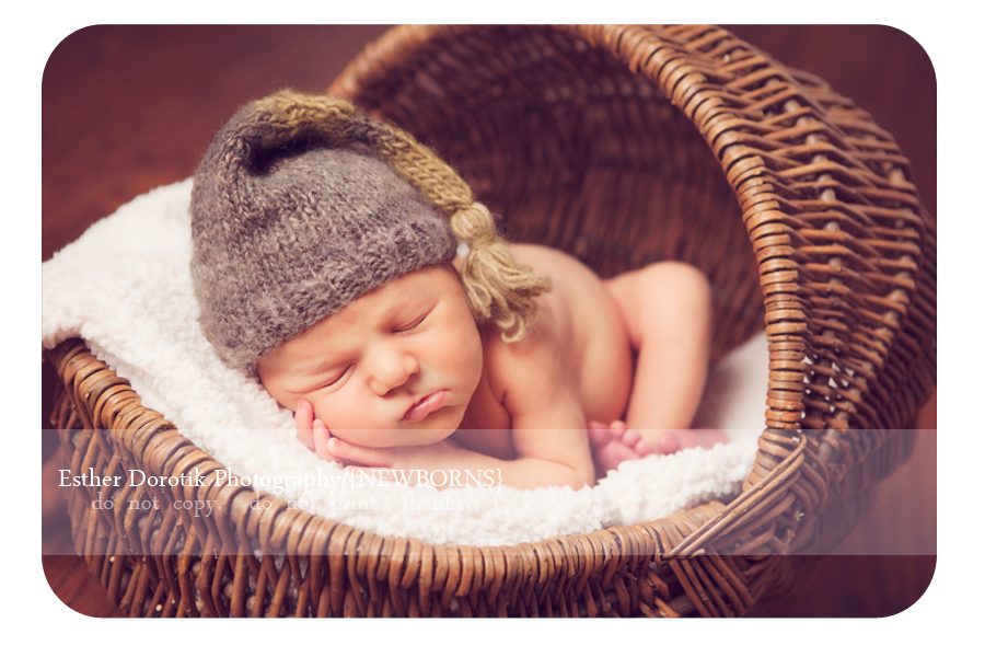 newborn-baby-boy-laying-in-basket-with-cream-blanket